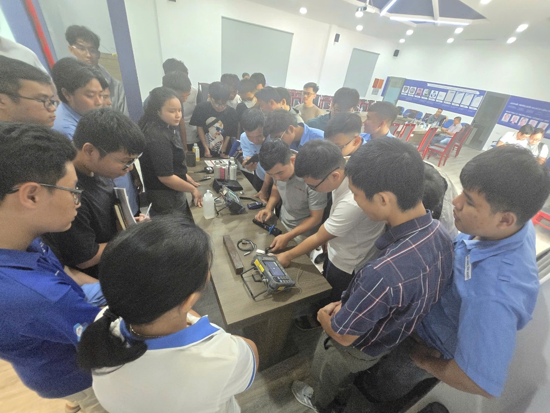 A group of people working on a machine

AI-generated content may be incorrect.